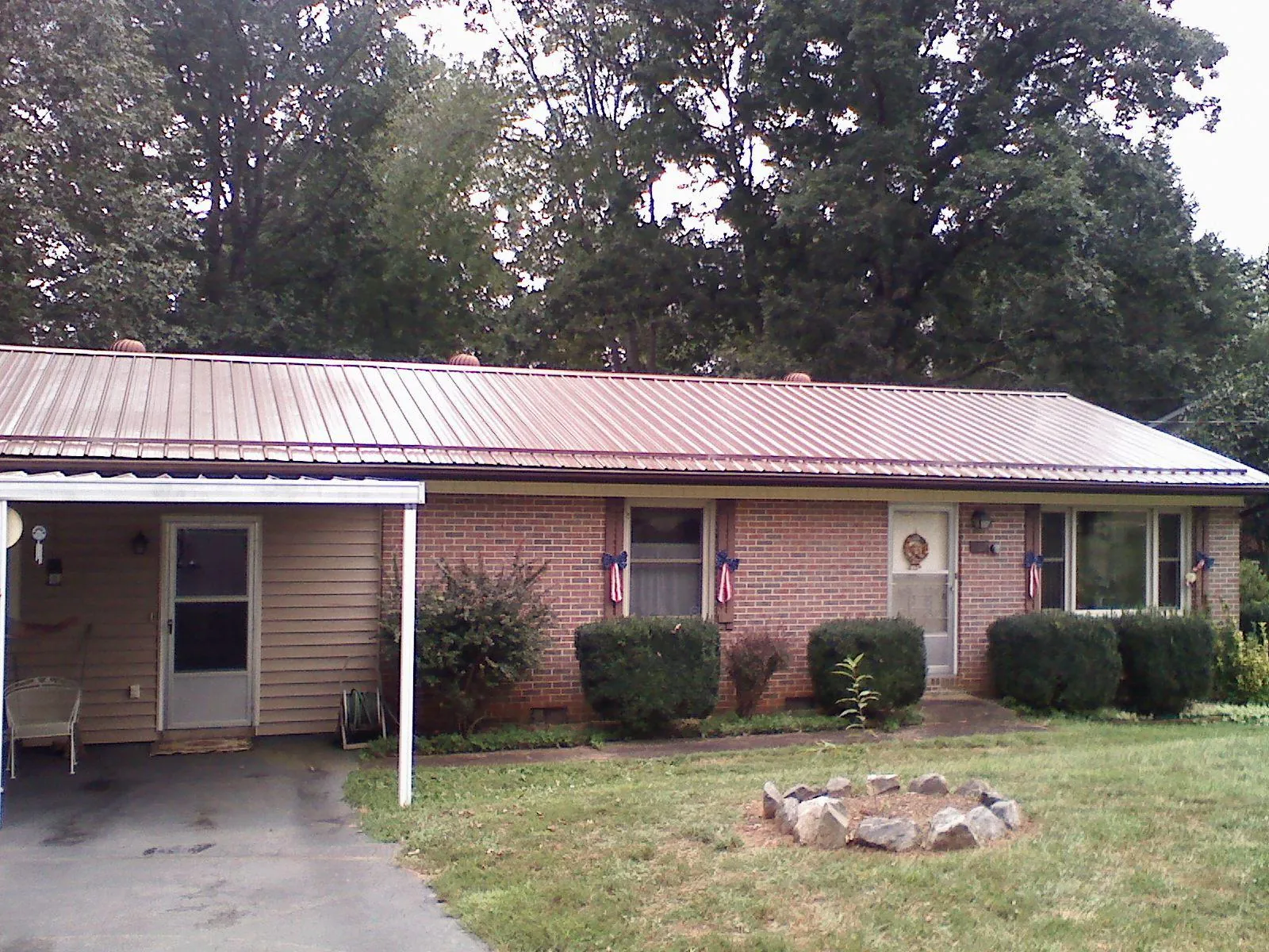 Bronze metal roof and carport on a brick ranch home — Roof Repair work by our crew in Gerrardstown